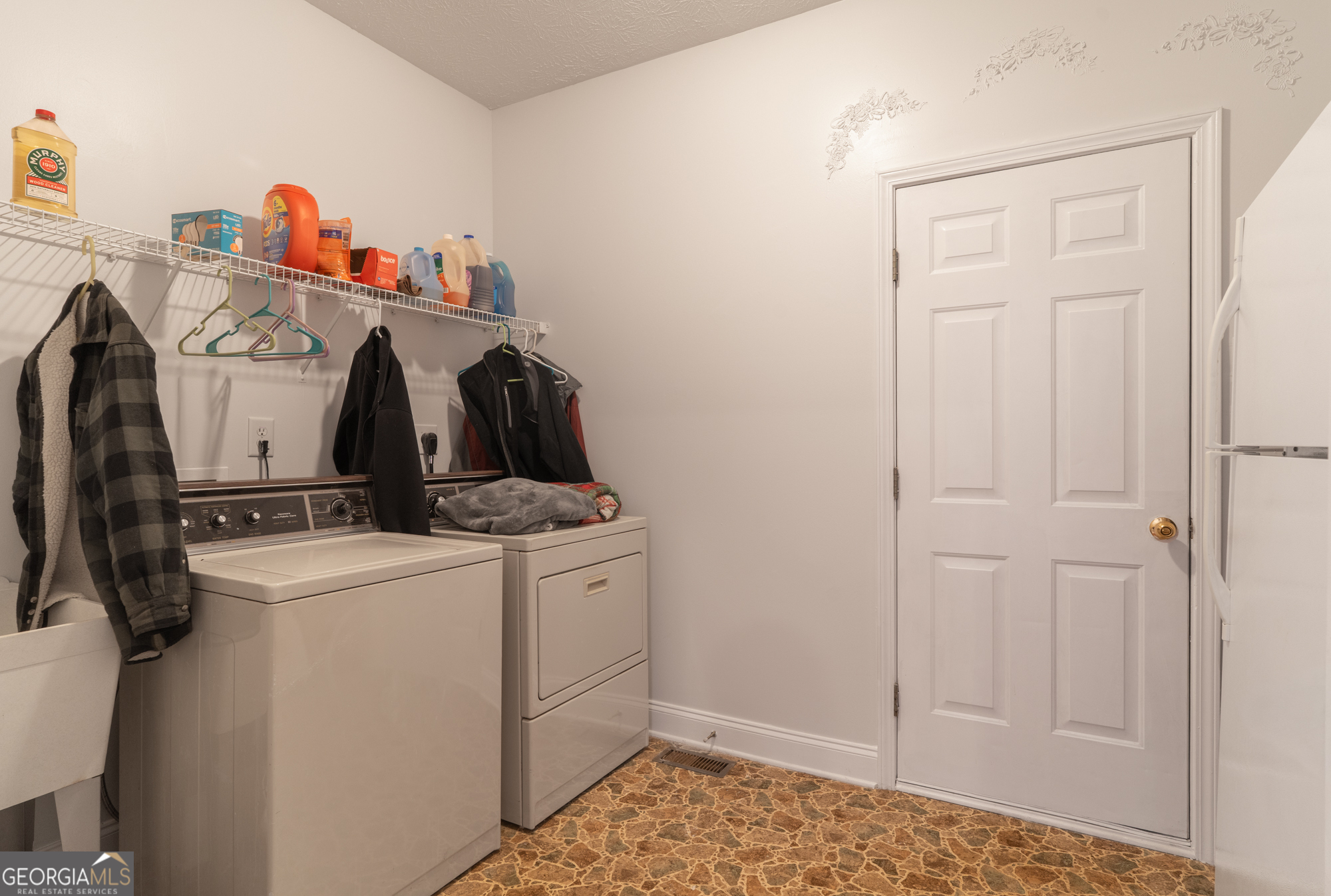 724 Teamon Road Griffin, GA 30223 - Photo 32 of 50 a view of storage and utility room with washer and dryer