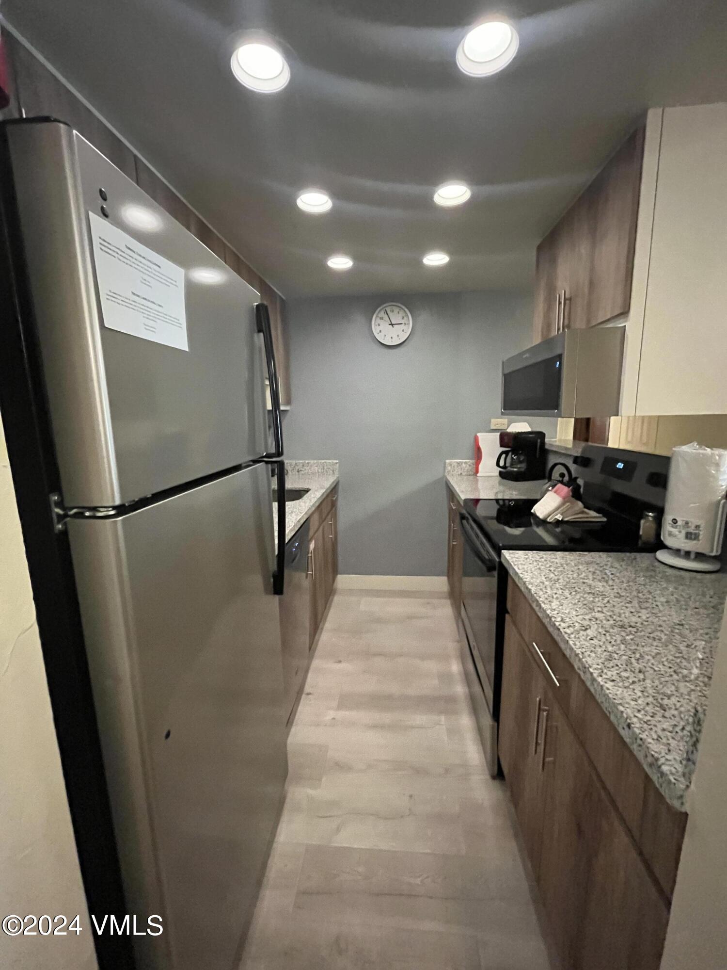 1020 Vail View Drive, Unit 110839 Vail, CO 81657 - Photo 1 of 21 a kitchen with stainless steel appliances granite countertop a sink stove and refrigerator