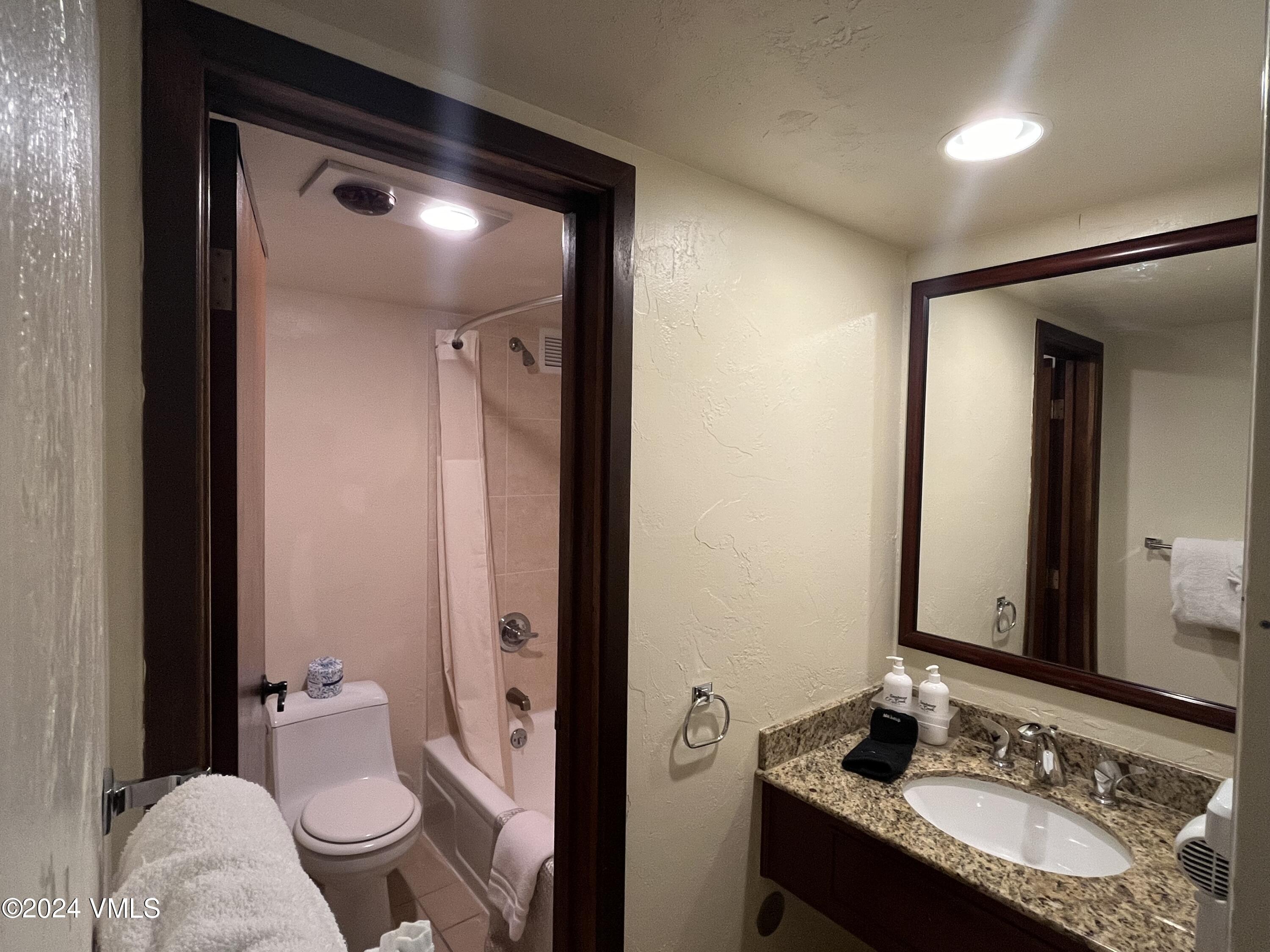 1020 Vail View Drive, Unit 110839 Vail, CO 81657 - Photo 7 of 21 a bathroom with a granite countertop sink toilet and shower