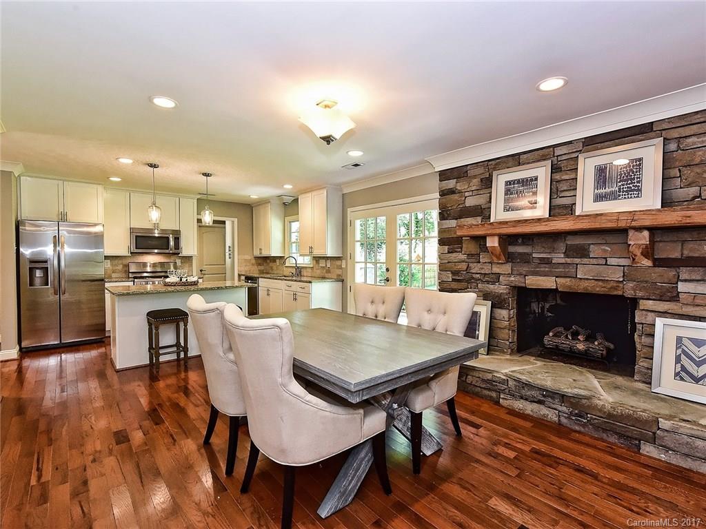 4116 Randolph Road Charlotte, NC 28211 - Photo 8 of 24 a kitchen with a table chairs refrigerator and cabinets