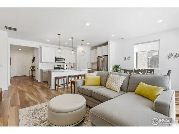 a living room with furniture and kitchen view