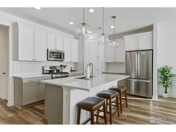a kitchen with kitchen island a counter top space appliances and cabinets