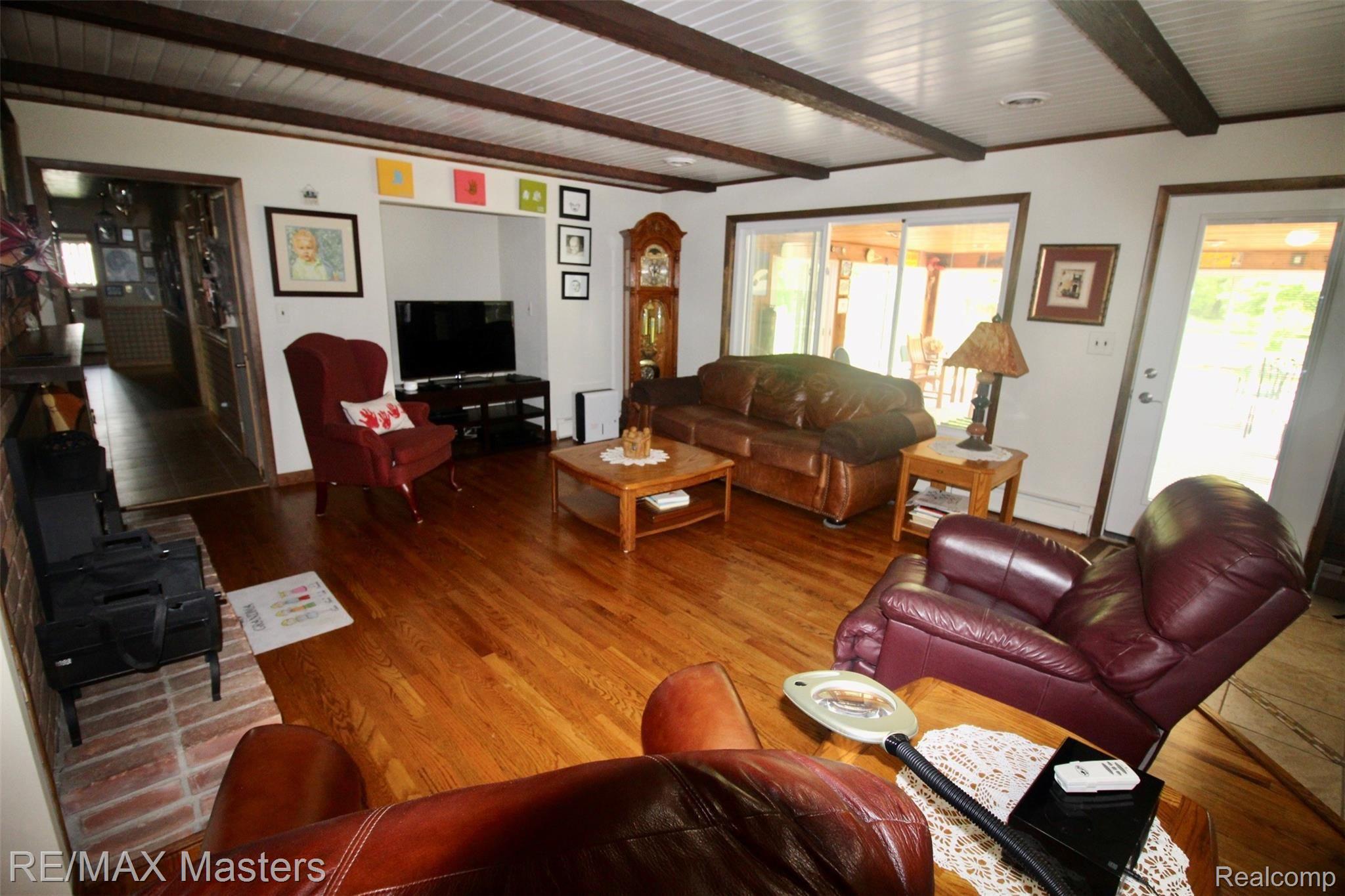 25777 Inkster Road Flat Rock, MI 48134 - Photo 9 of 52 The spacious family room with hardwood floors at the rear of the house, offers some of the best seats in the house! Woodburning fireplace heats the room(s), while you sit back and relax and catch some late night TV