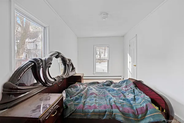a bedroom with bed and a window