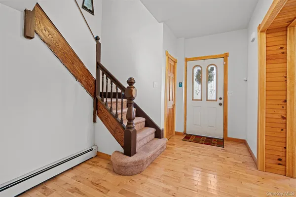a view of entryway with wooden floor and stairs