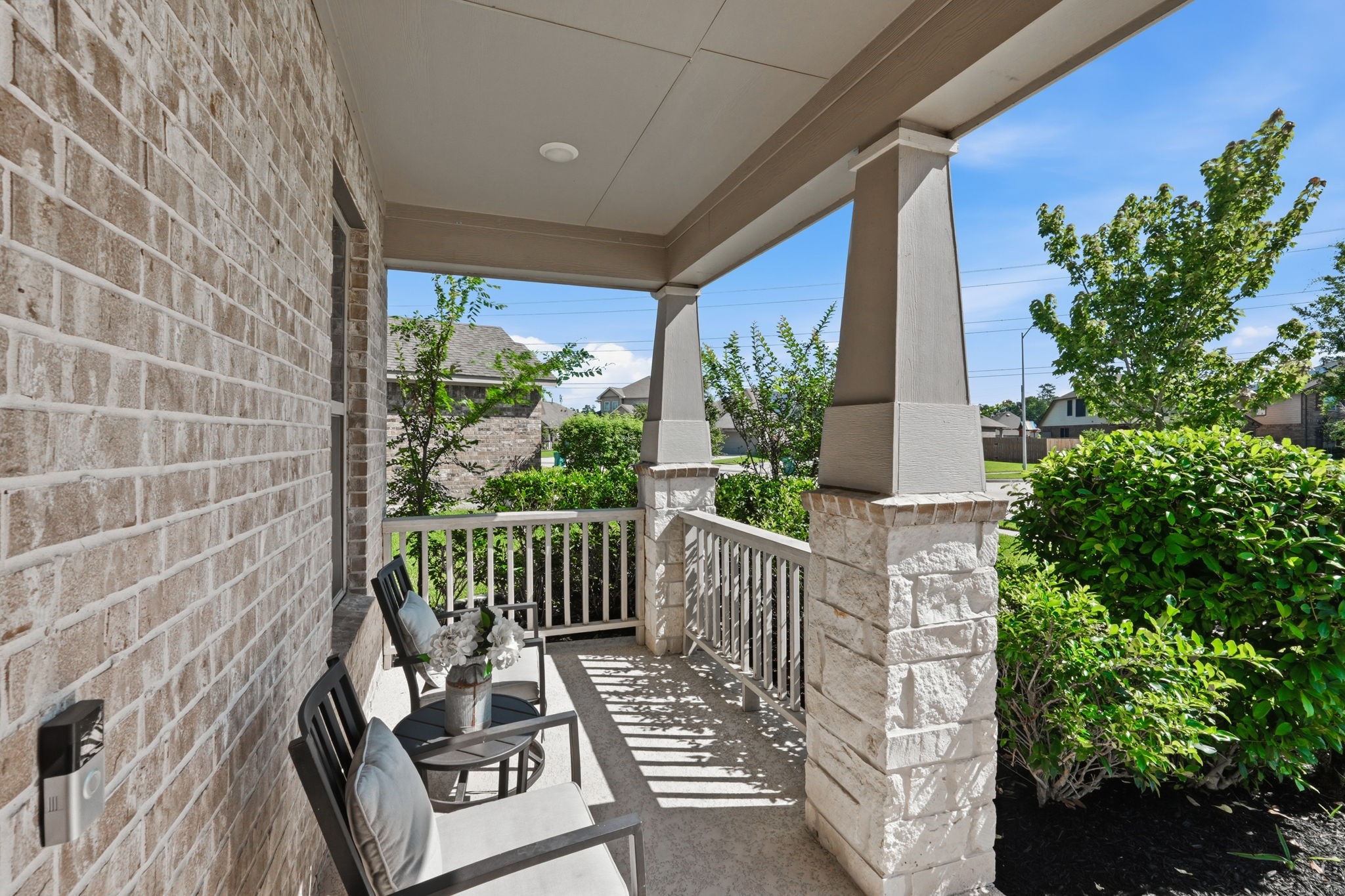 4334 Umber Shadow Drive Spring, TX 77386 - Photo 6 of 45 Covered front porch provides a welcoming outdoor space framed by stone masonry, recessed lighting, and mature landscaping.