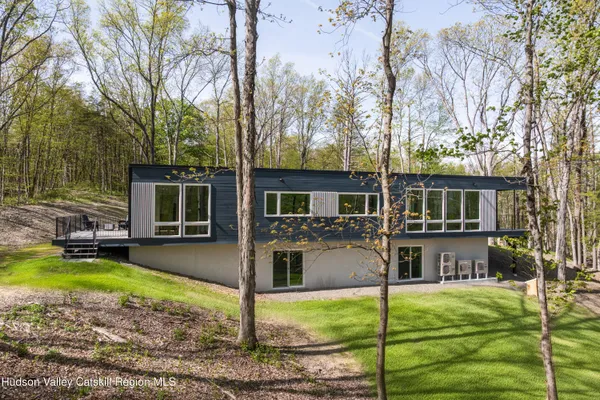 a view of a house with a yard chairs and fire pit