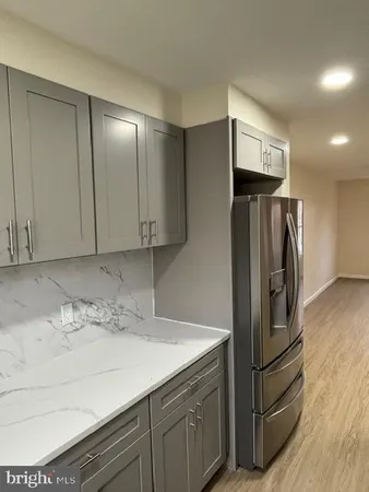a kitchen with stainless steel appliances granite countertop a refrigerator and a sink