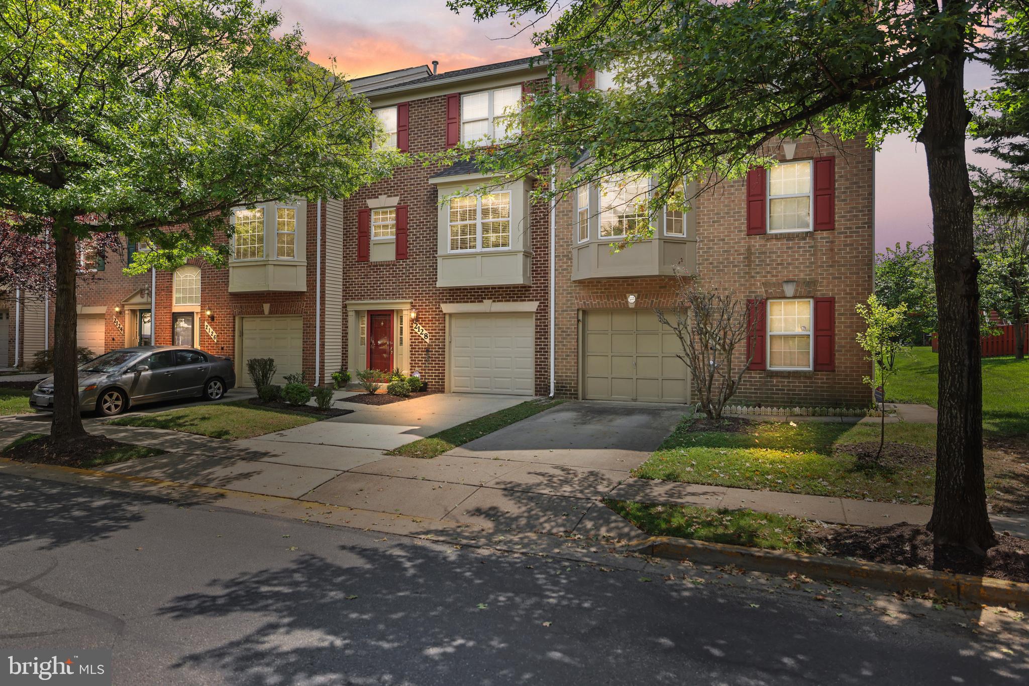 2128 Elm Tree Lane Silver Spring, MD 20906 - Photo 1 of 55 a view of a yard in front of a brick house with large windows