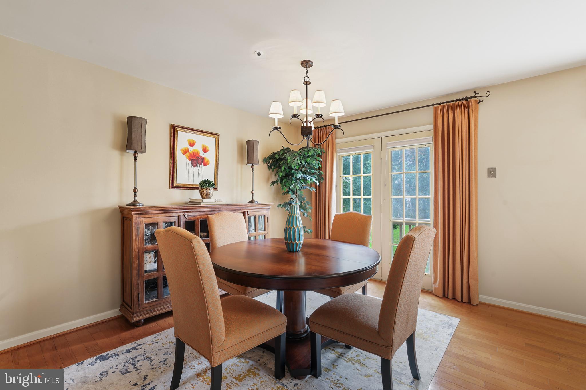 2128 Elm Tree Lane Silver Spring, MD 20906 - Photo 13 of 55 a dining room with furniture a chandelier and wooden floor
