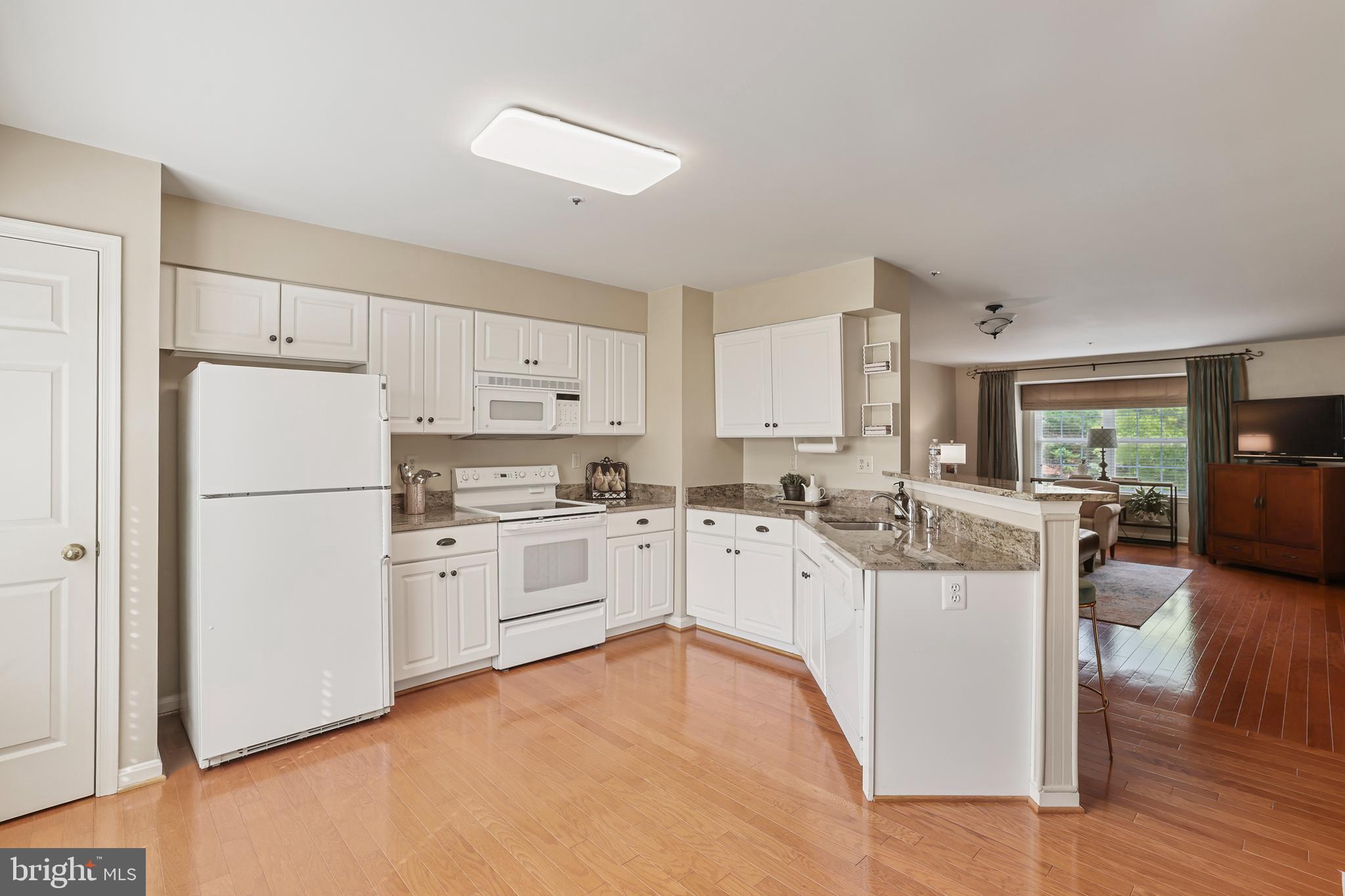 2128 Elm Tree Lane Silver Spring, MD 20906 - Photo 15 of 55 a kitchen with white cabinets and white appliances
