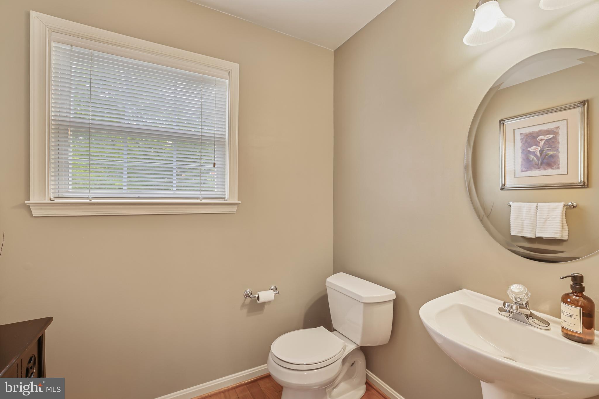 2128 Elm Tree Lane Silver Spring, MD 20906 - Photo 20 of 55 a white toilet sitting next to a bathroom sink