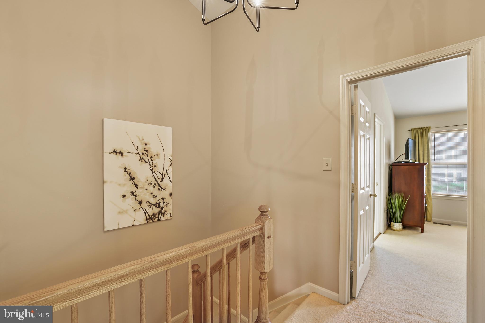 2128 Elm Tree Lane Silver Spring, MD 20906 - Photo 21 of 55 a view of a hallway with paintings on the wall