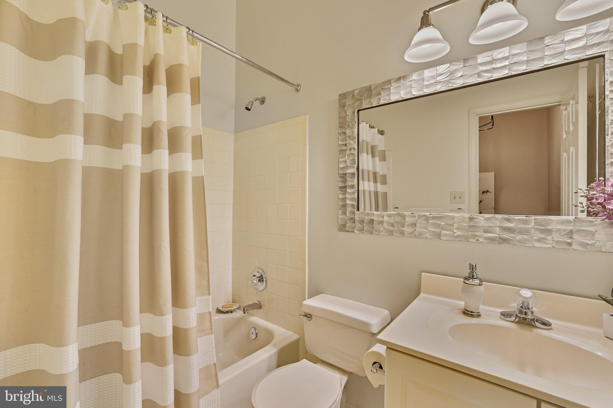2128 Elm Tree Lane Silver Spring, MD 20906 - Photo 31 of 55 a bathroom with a sink mirror and a toilet