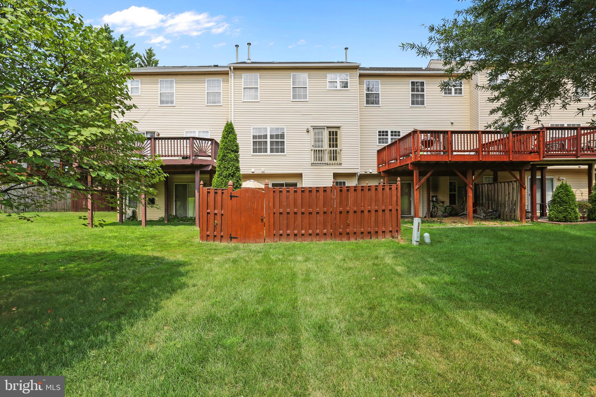 2128 Elm Tree Lane Silver Spring, MD 20906 - Photo 36 of 55 a front view of a house with a garden and deck