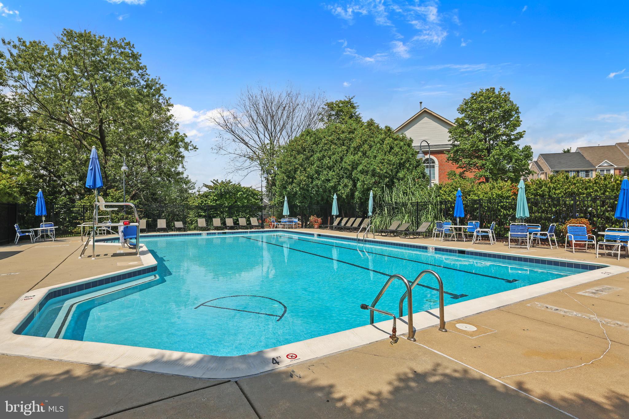 2128 Elm Tree Lane Silver Spring, MD 20906 - Photo 44 of 55 a view of swimming pool with outdoor seating and trees in the background