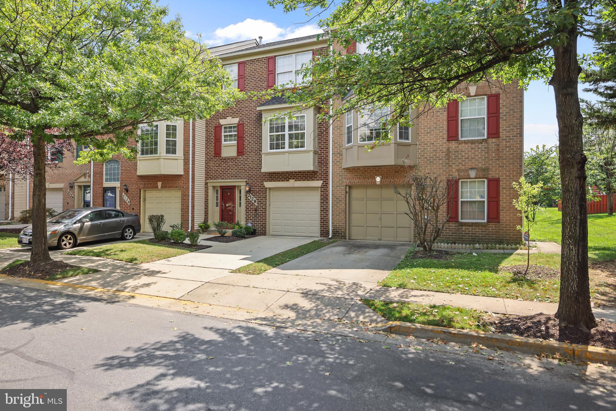 2128 Elm Tree Lane Silver Spring, MD 20906 - Photo 48 of 55 a front view of a house with a yard and garage