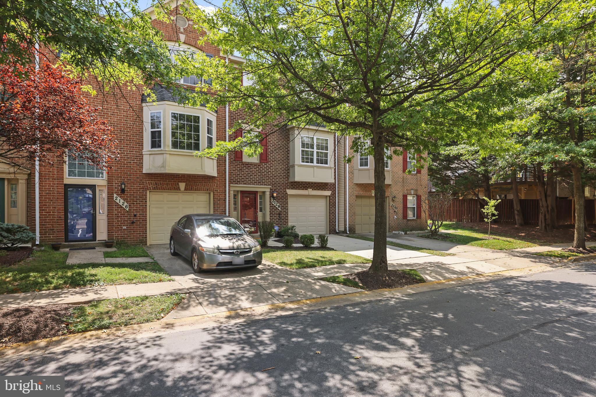 2128 Elm Tree Lane Silver Spring, MD 20906 - Photo 50 of 55 a front view of a house with a yard