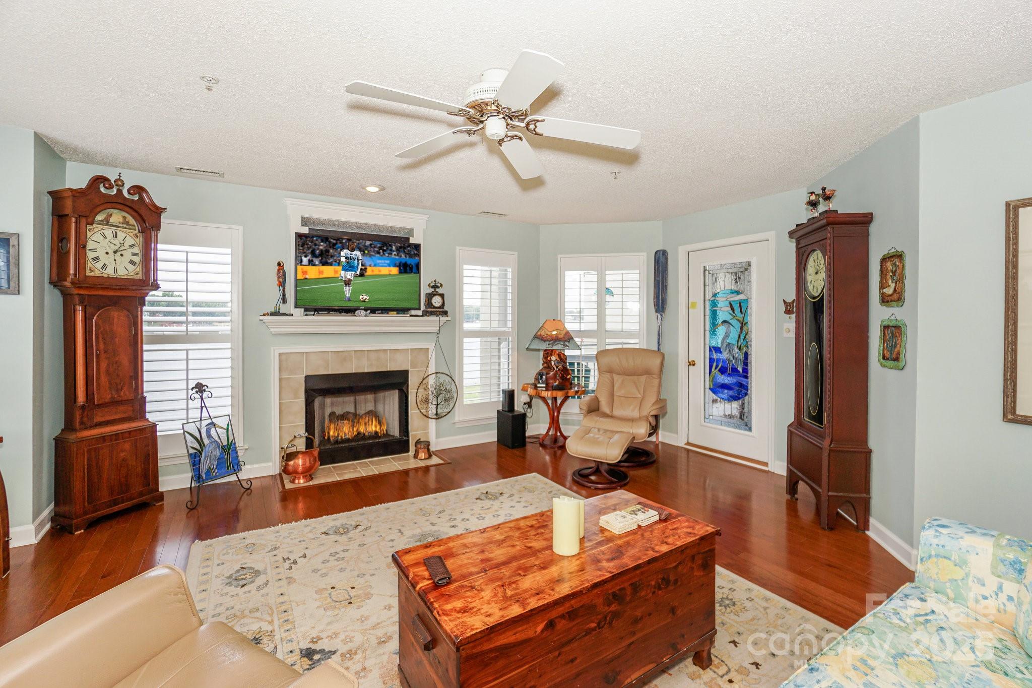 1238 Torrence Circle Davidson, NC 28036 - Photo 12 of 43 a living room with furniture a flat screen tv and a fireplace