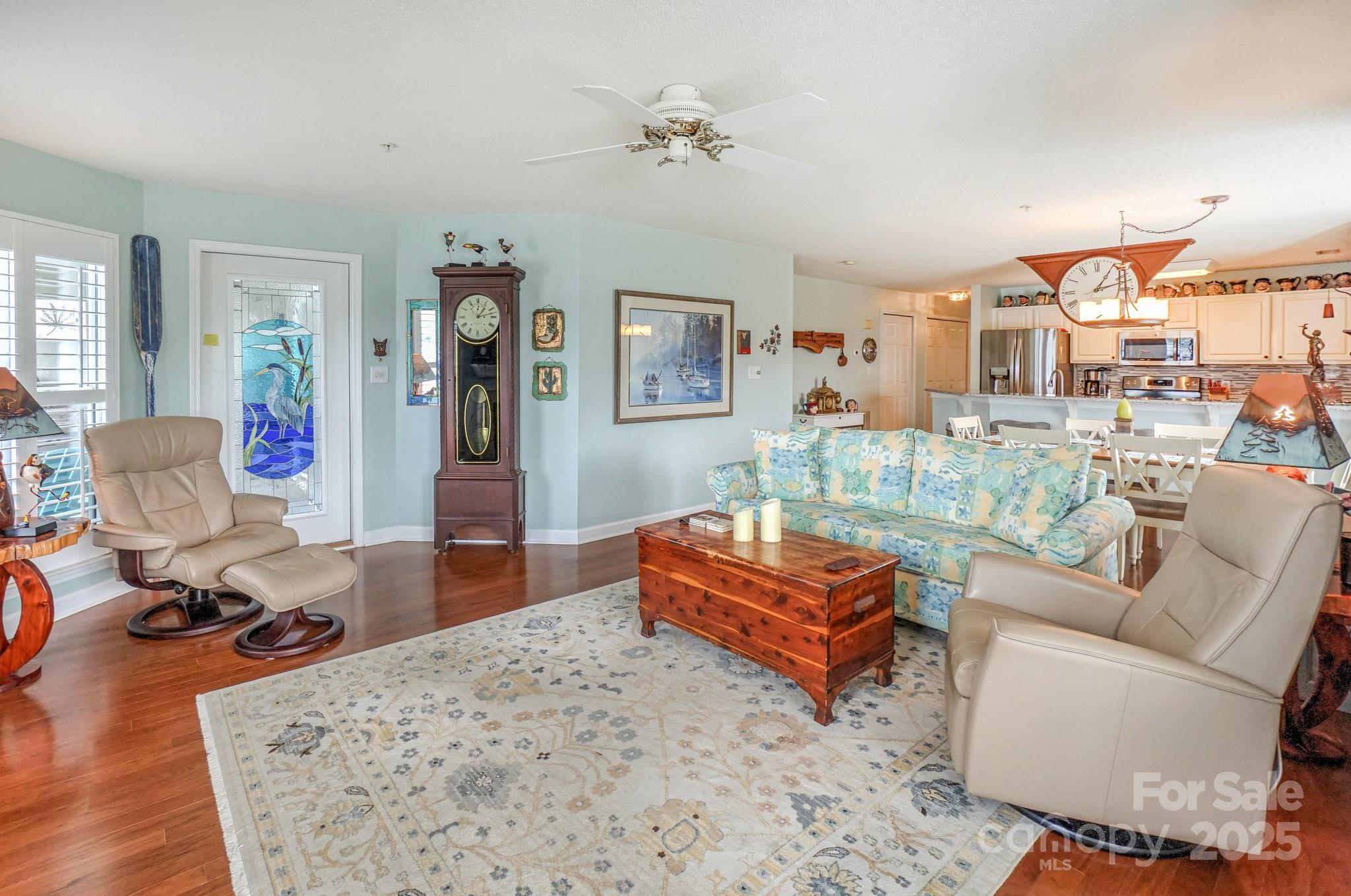 1238 Torrence Circle Davidson, NC 28036 - Photo 16 of 43 a living room with furniture a rug and a chandelier