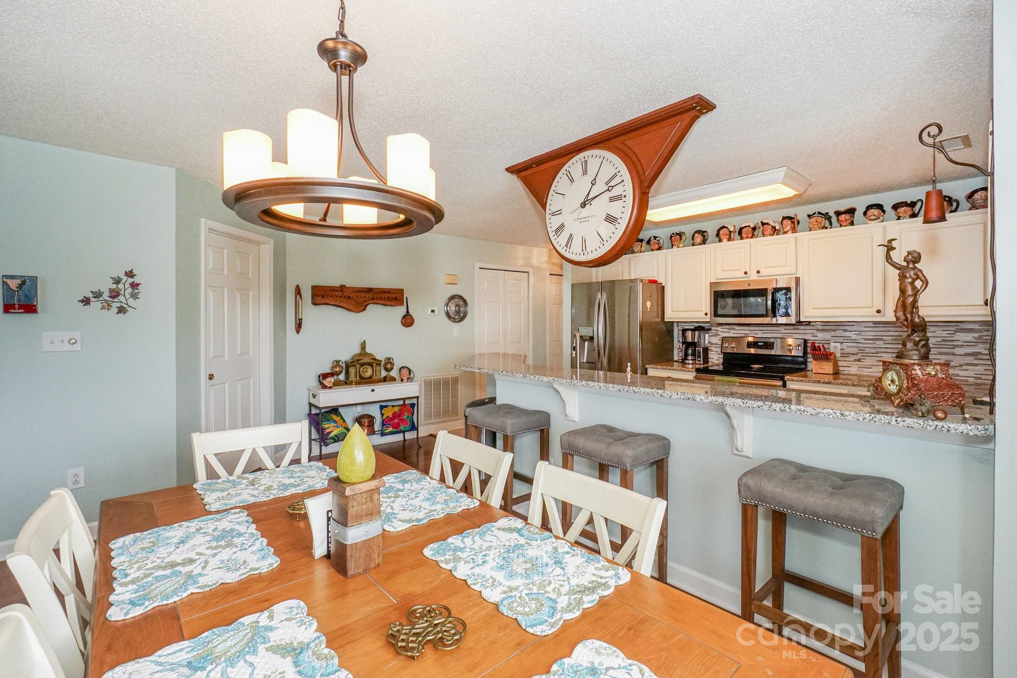 1238 Torrence Circle Davidson, NC 28036 - Photo 18 of 43 a living room with furniture a rug and a clock