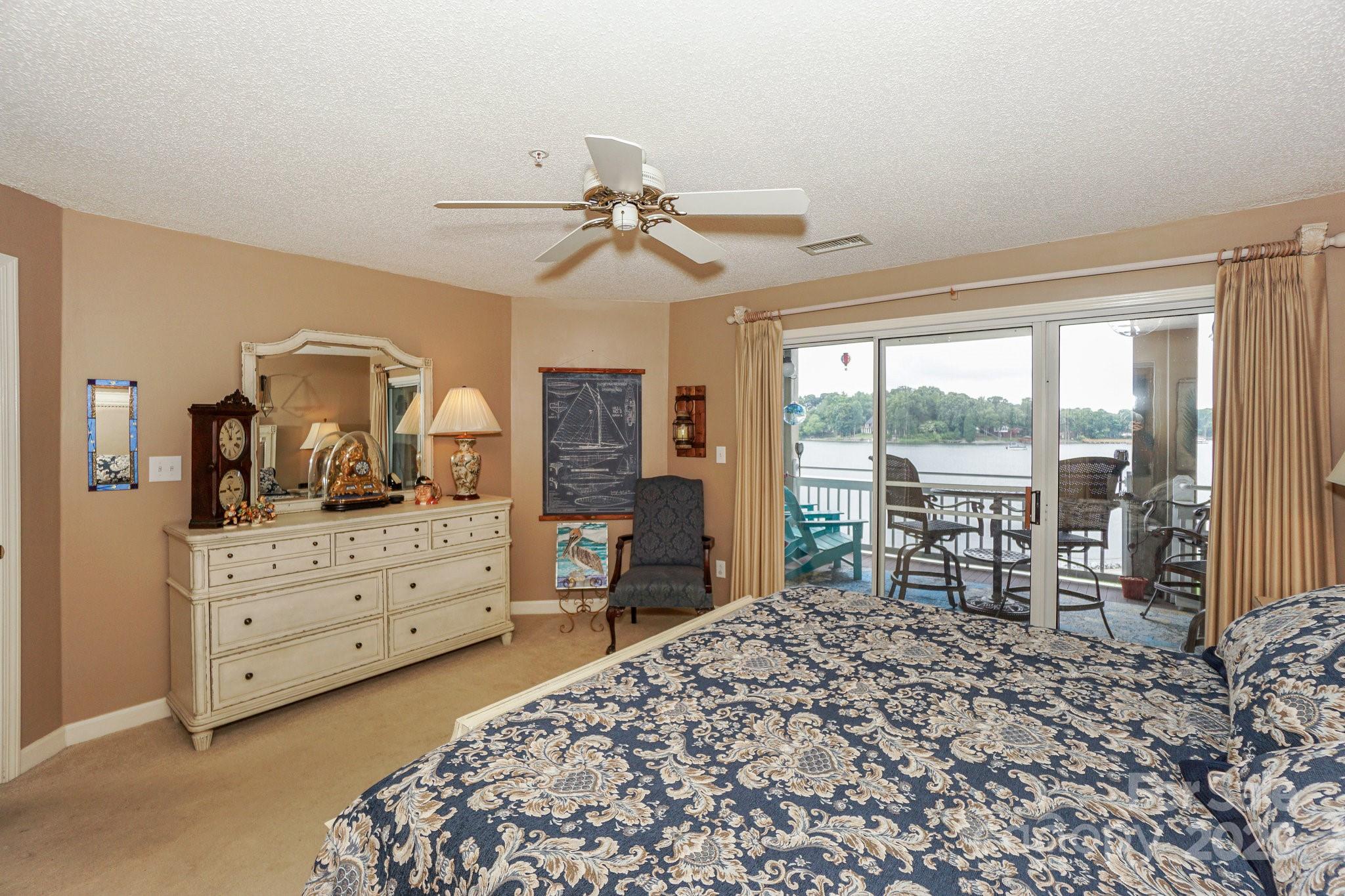 1238 Torrence Circle Davidson, NC 28036 - Photo 23 of 43 a bedroom with a large bed and a dresser