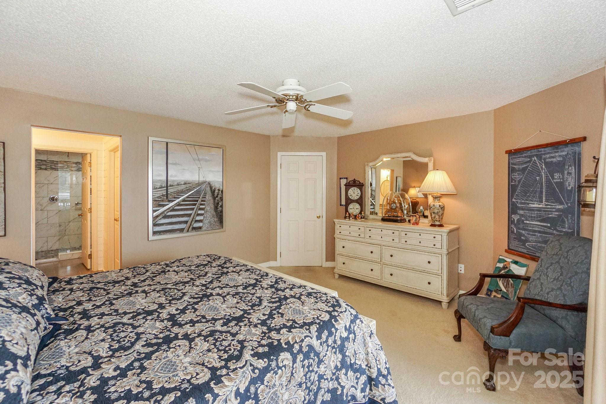 1238 Torrence Circle Davidson, NC 28036 - Photo 24 of 43 a bedroom with a bed and a dresser with mirror