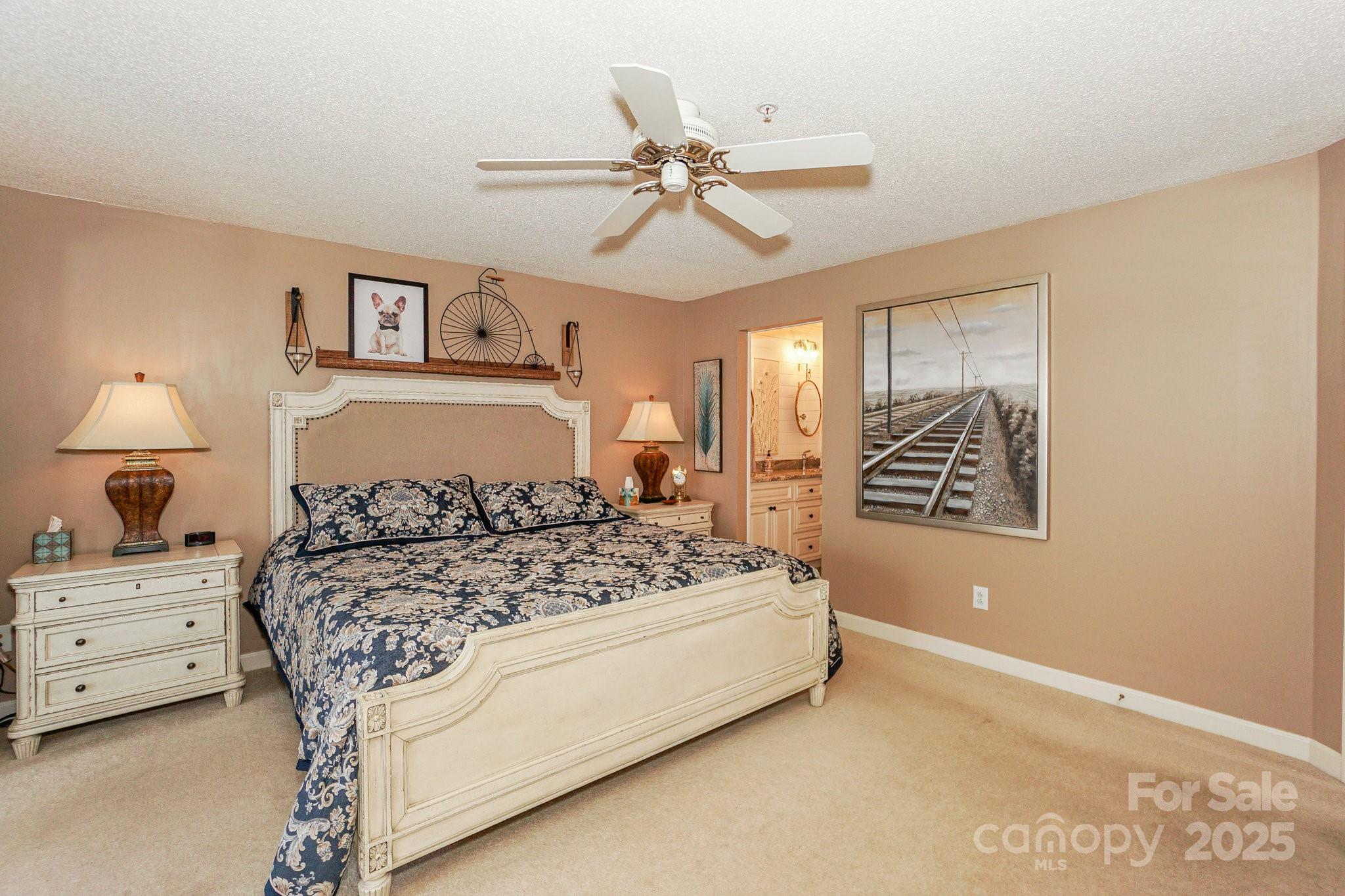 1238 Torrence Circle Davidson, NC 28036 - Photo 25 of 43 a bedroom with a bed and a chandelier