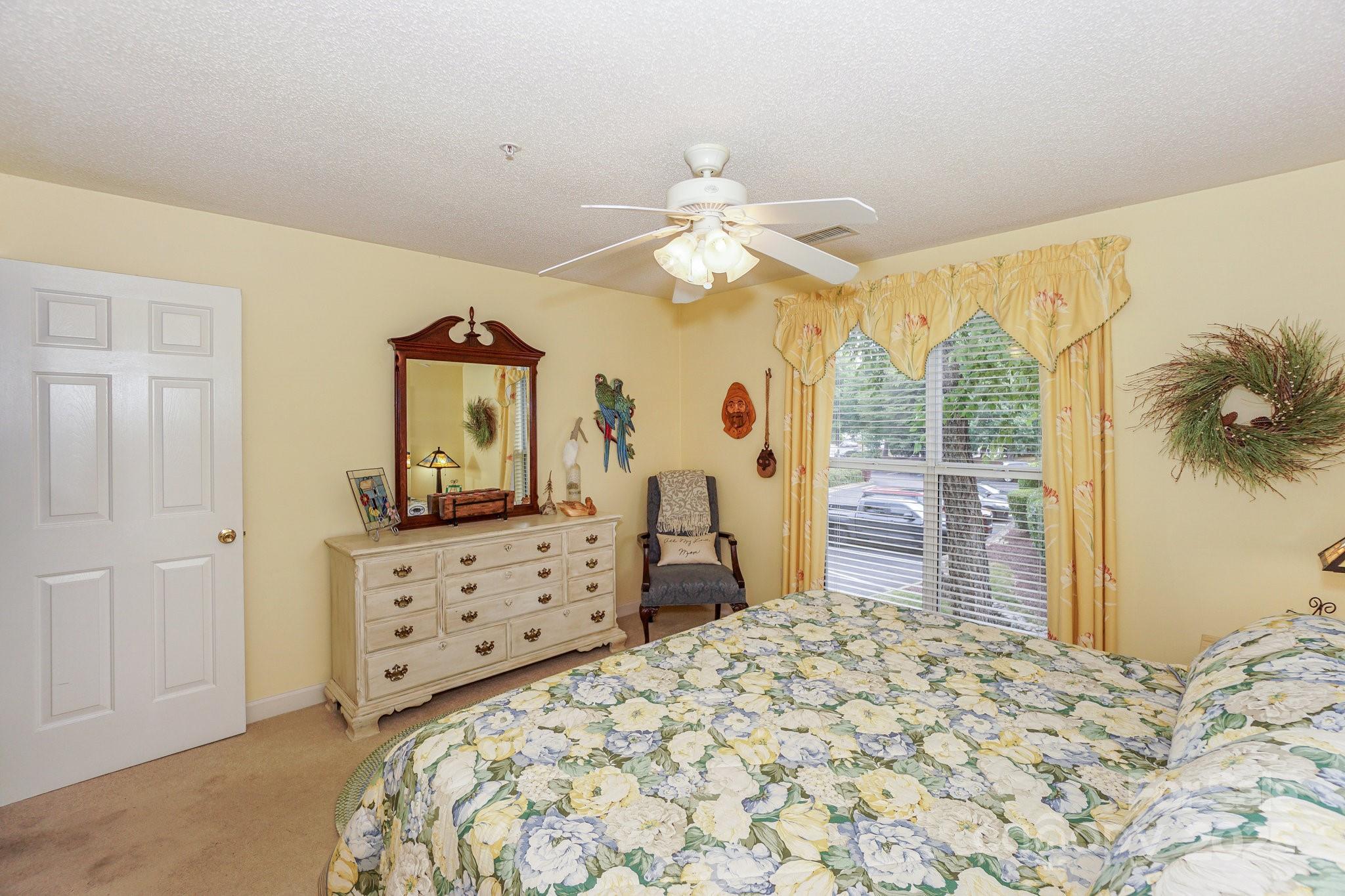 1238 Torrence Circle Davidson, NC 28036 - Photo 34 of 43 a bedroom with a bed dresser and a flat tv screen