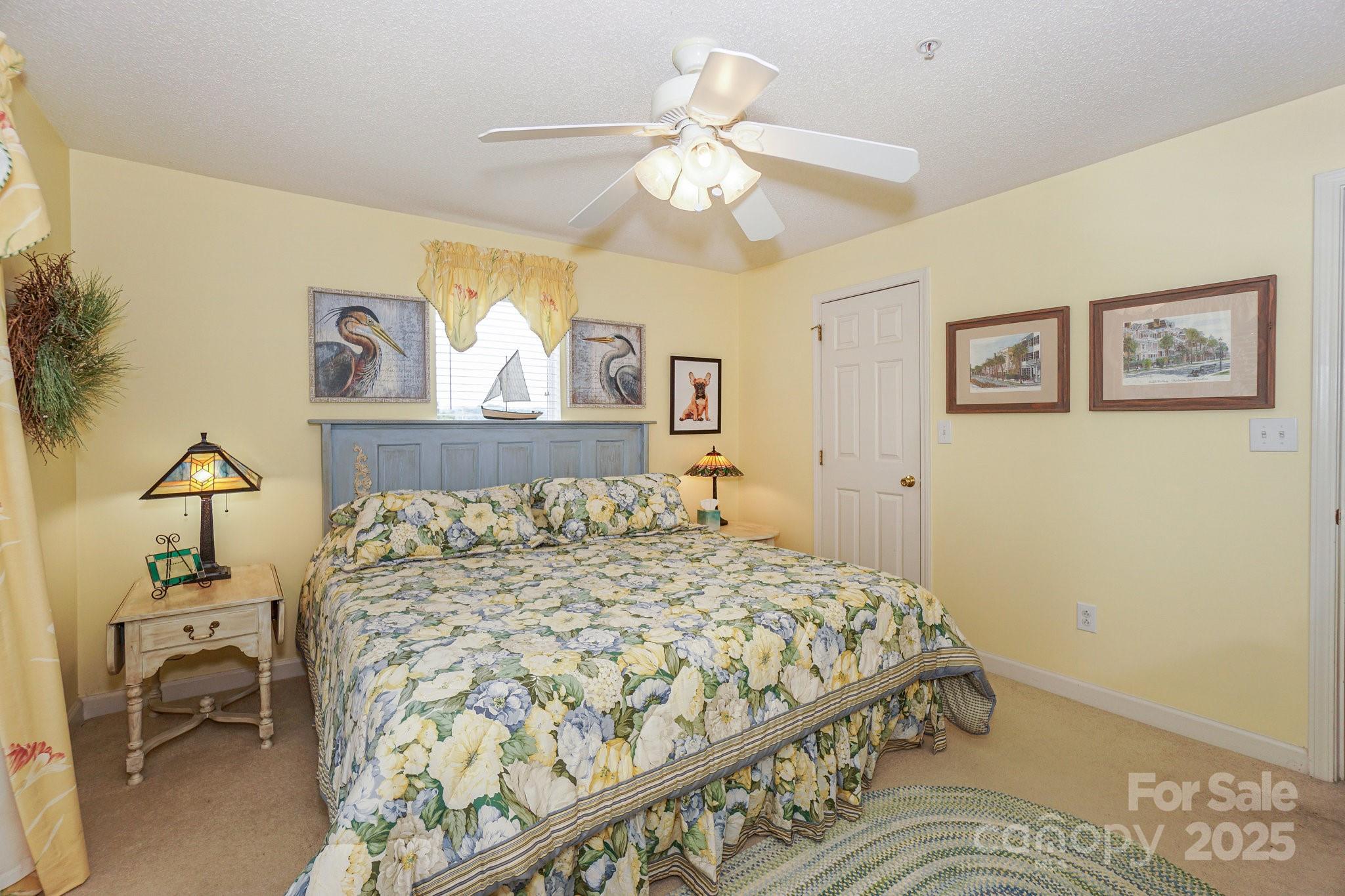 1238 Torrence Circle Davidson, NC 28036 - Photo 35 of 43 a bedroom with a bed and a chandelier