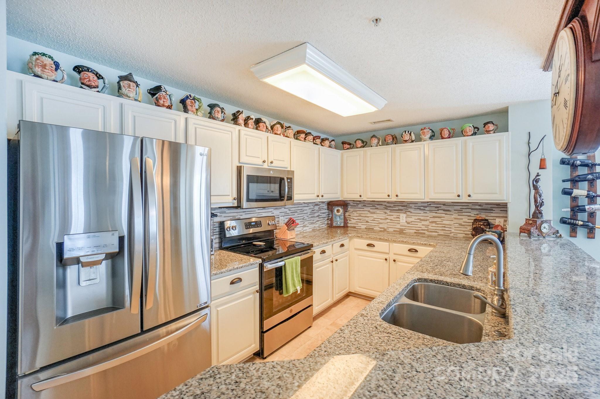 1238 Torrence Circle Davidson, NC 28036 - Photo 5 of 43 a kitchen with granite countertop a refrigerator stove and sink