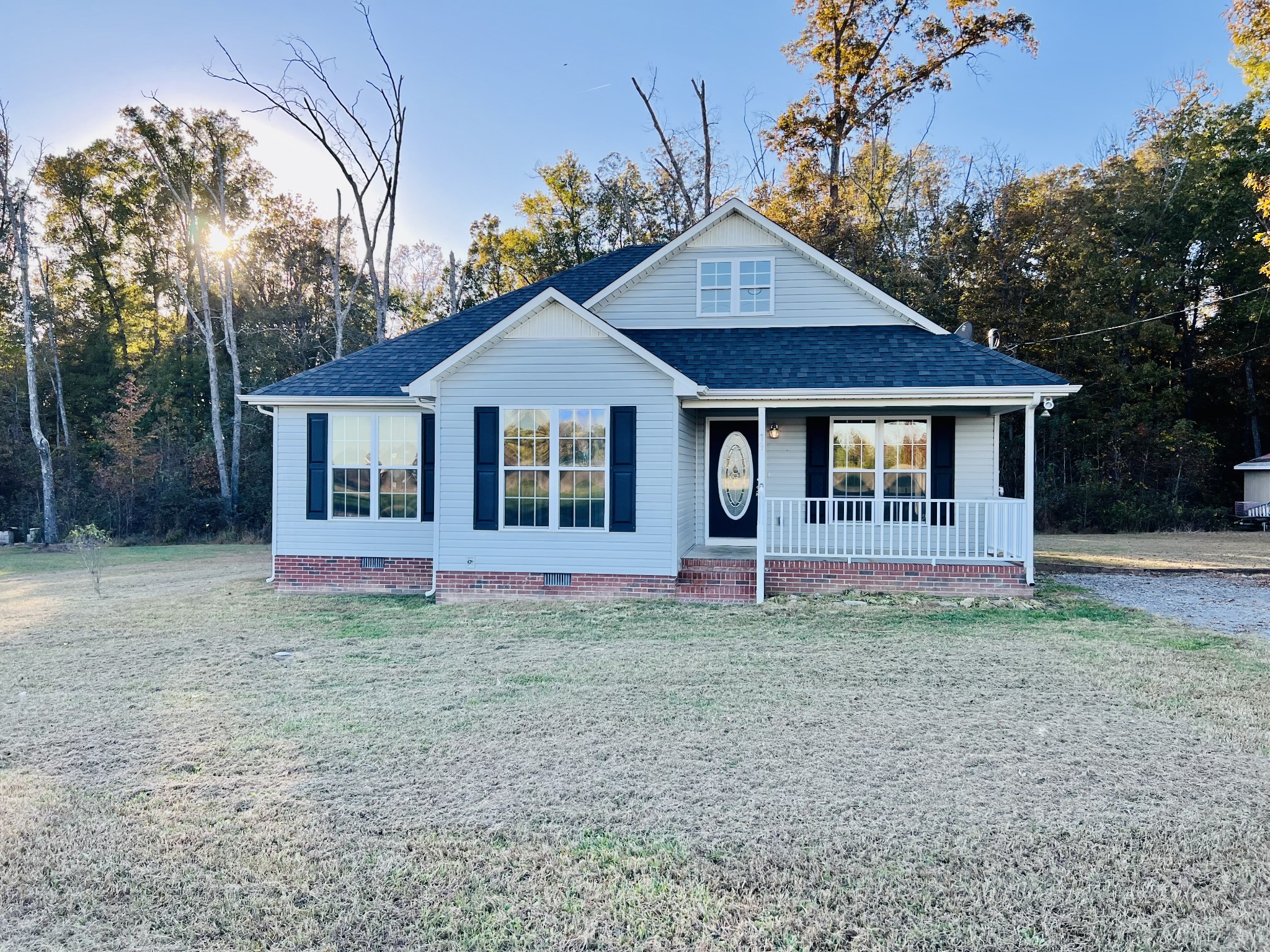 79 Benson School Road Kelso, TN 37348 - Photo 20 of 24 a front view of a house with a garden and trees