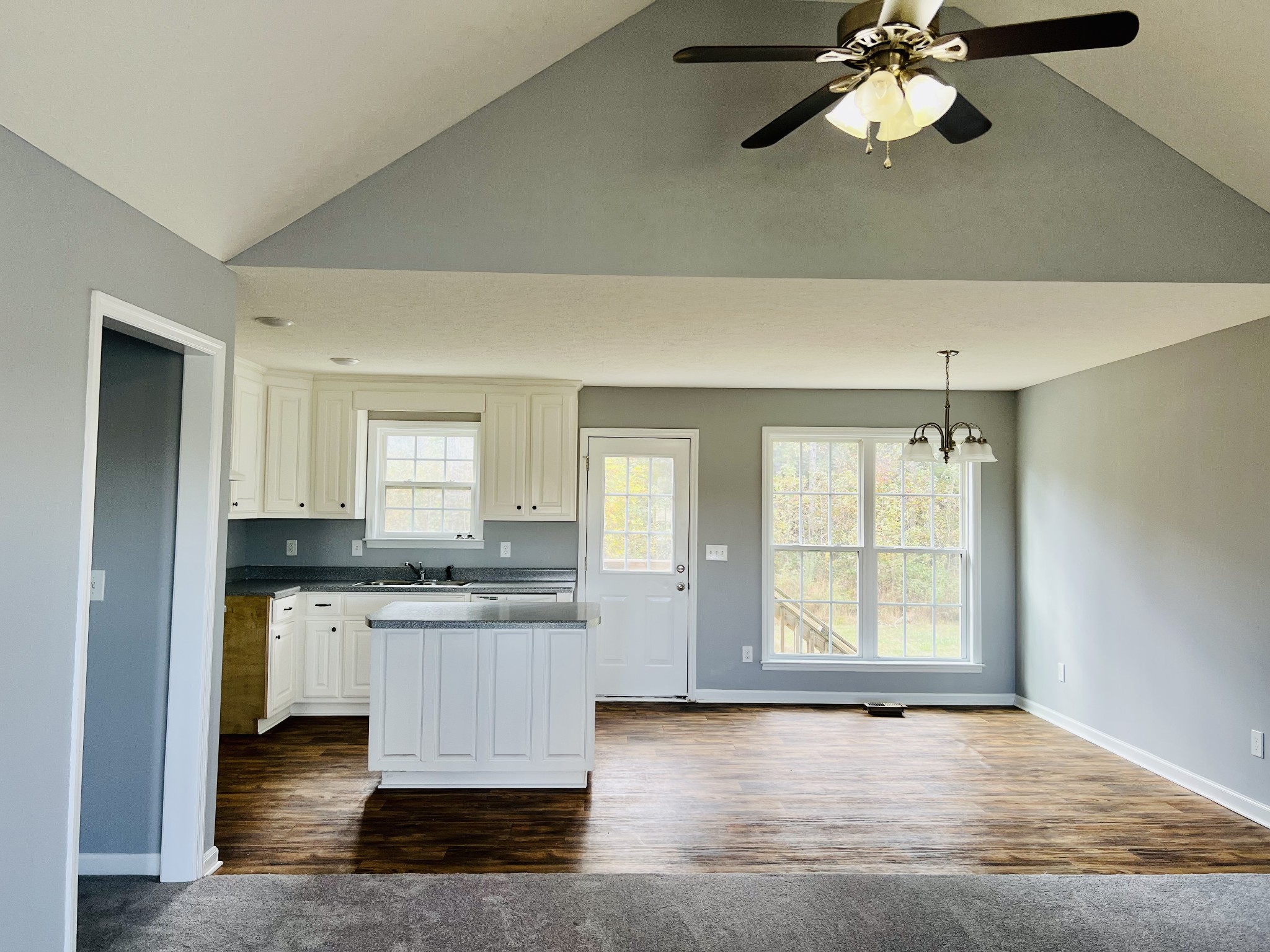 79 Benson School Road Kelso, TN 37348 - Photo 5 of 24 an empty room with a kitchen island white cabinets and wooden floor