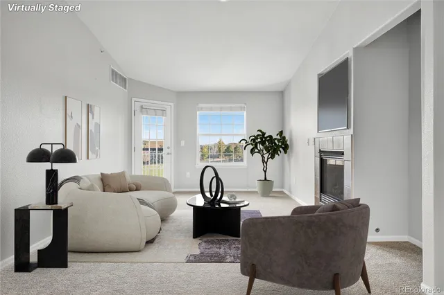 a living room with furniture and a lamp