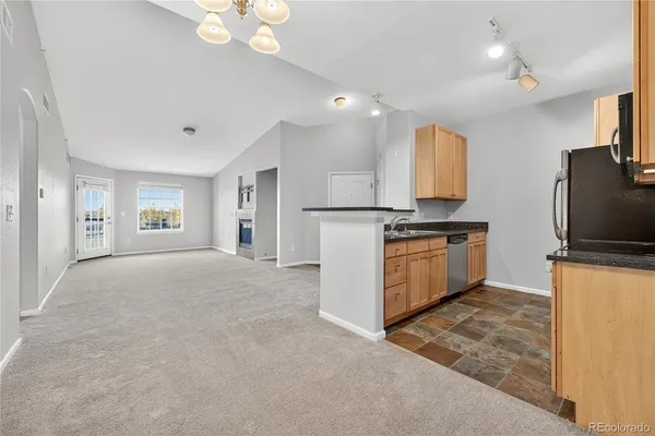 a kitchen with stainless steel appliances a refrigerator sink and stove