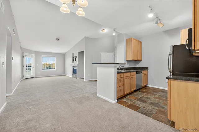 a kitchen with stainless steel appliances a refrigerator sink and stove