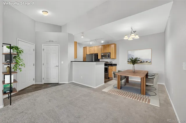 a view of a dining room with furniture and chandelier