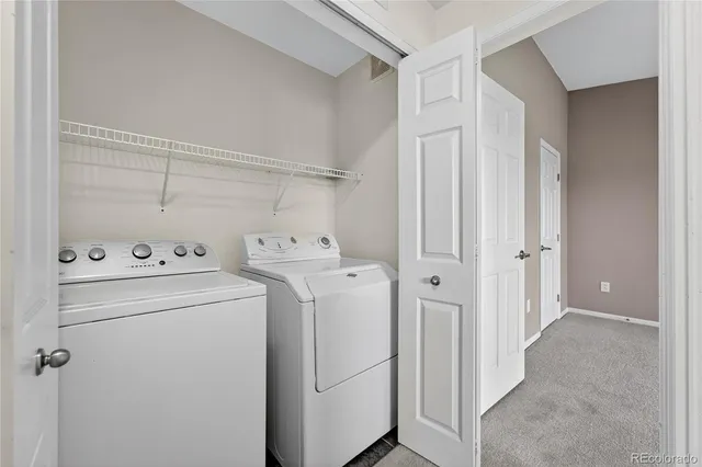 a view of storage and utility room with washer and dryer