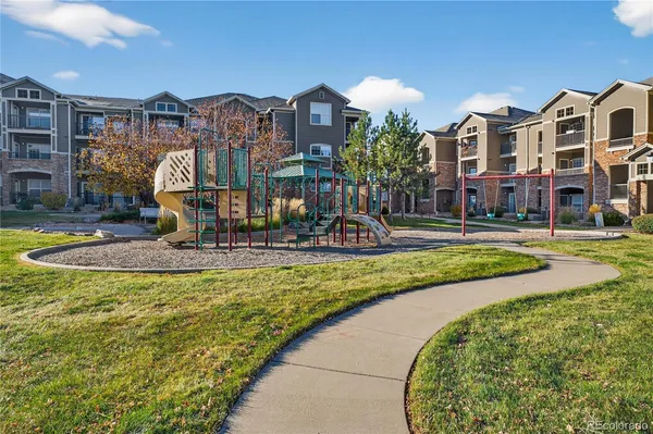 a front view of residential houses with yard and swimming pool