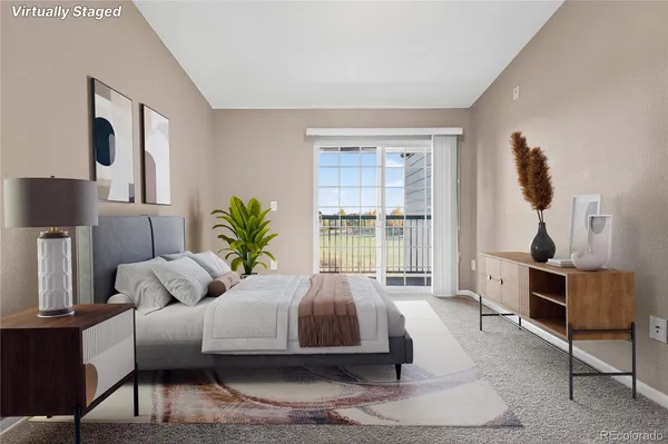 a bedroom with a bed potted plant with the dresser