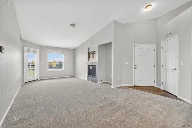 a view of empty room with windows and cabinet