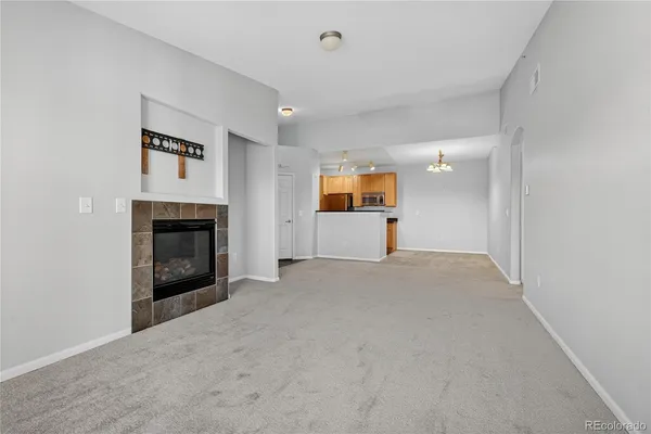 a view of empty room with a fireplace