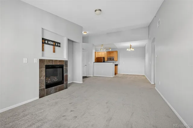 a view of empty room with a fireplace