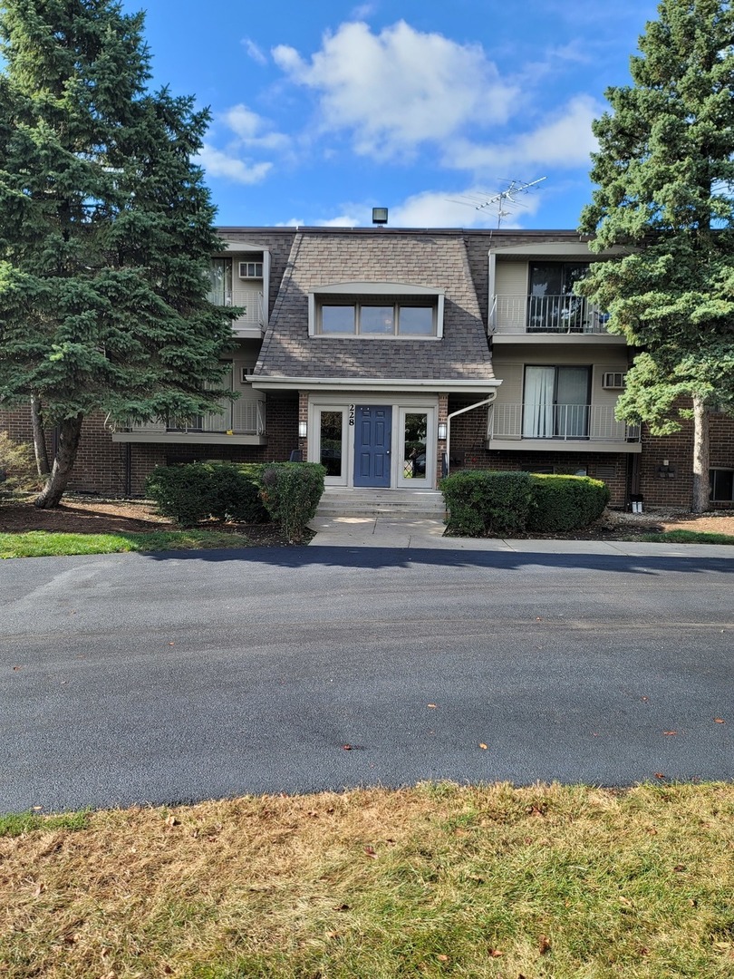 228 East Bailey Road, Unit H Naperville, IL 60565 - Photo 1 of 1 a front view of a house with a yard and garage