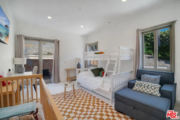 a living room with furniture a table and a large window