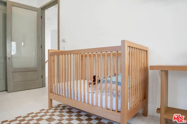 a bedroom with a bed and large window