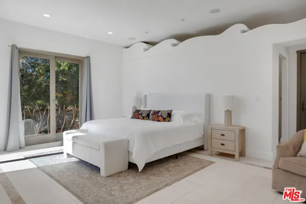 a bedroom with a bed and a table