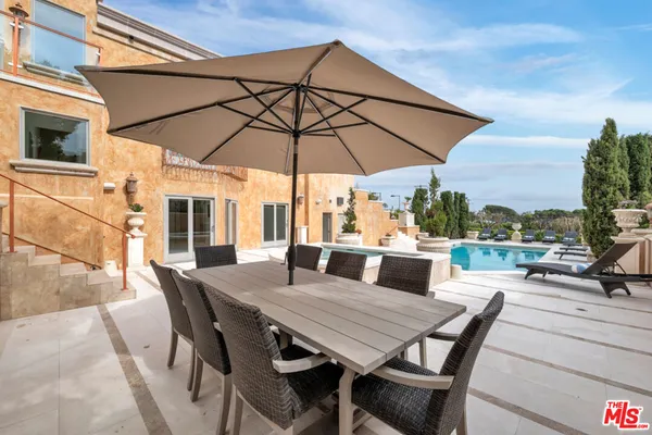 a view of an outdoor space with furniture and umbrella