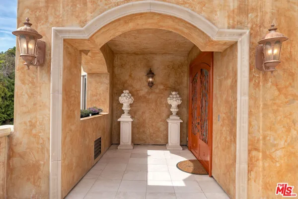 a view of a hallway with wooden shelves
