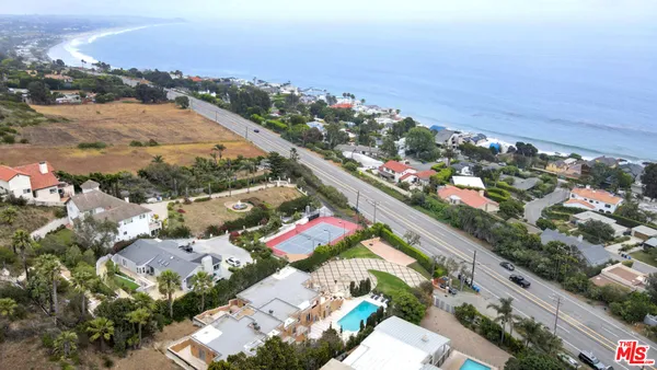 a view of a house with backyard porch and sitting area